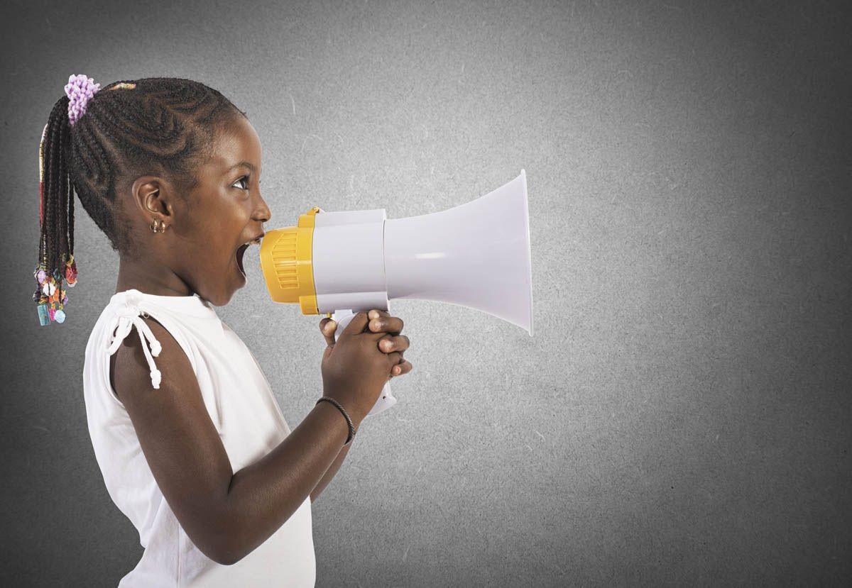 Little girl screaming and shouting with megaphone