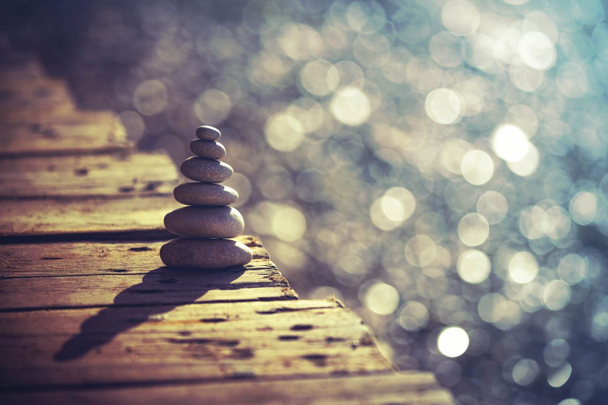 Inner peace and balance, pile of pebbles on the wooden bridge on the beach, summer vacation on the spa resort, life and harmony concept
